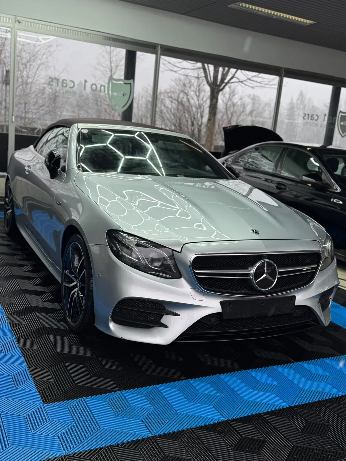 Mercedes E-Klasse Cabrio in der Halle von Saff Car Lounge in Kufstein nach der Aufbereitung, Hexagon-Leuchten spiegeln sich im Lack